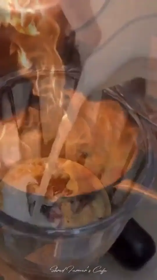 A wok flaring over an open flame as rice is tossed in the cafe kitchen