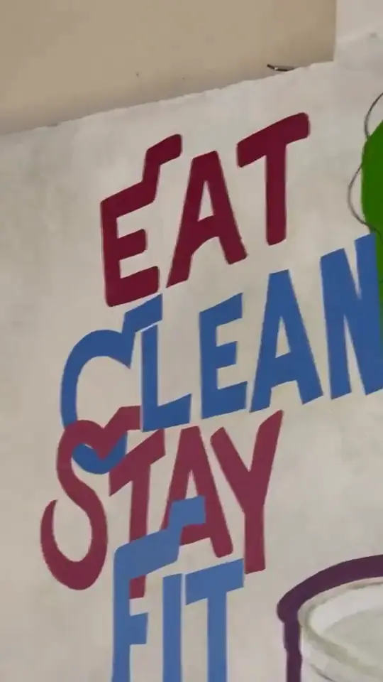 The Eat Clean Stay Fit mural being hand-painted before the cafe opened