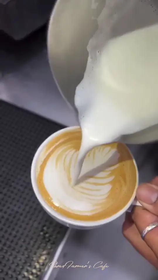 Gloved hands folding a wrap, then espresso being poured into a flat white