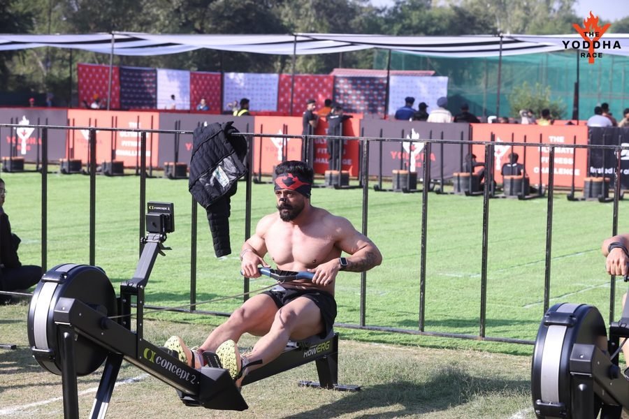 Satnaam mid-stroke on a Concept2 rower at the Yoddha Race